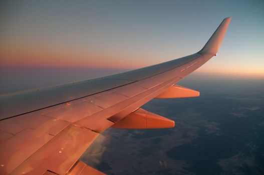 Sunset red sky scene from plane window