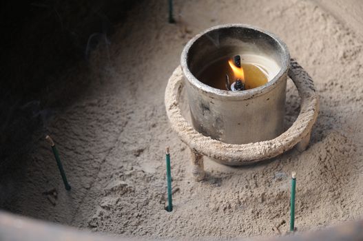 Burnt incense sticks in temple bowl