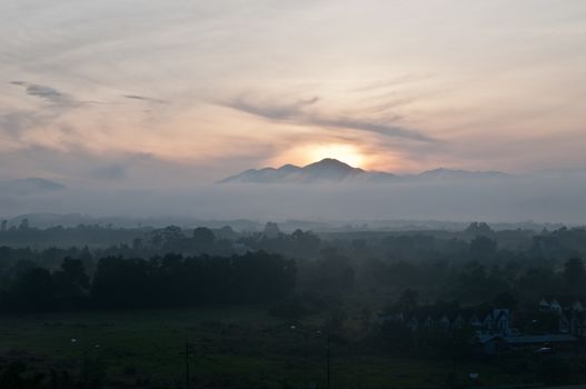 Early morning dawn in middle of cloudy jungle