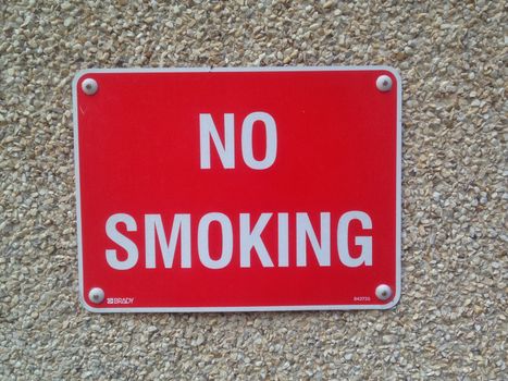 No smoking metal plate on wall