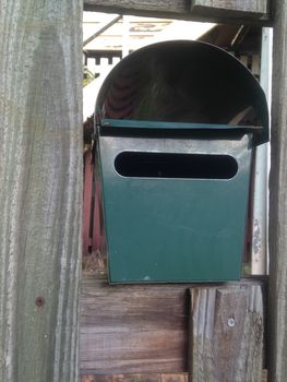 Green metal post box of a house