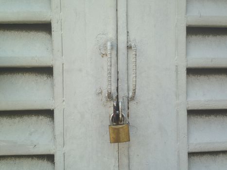Vintage closed door with golden lock