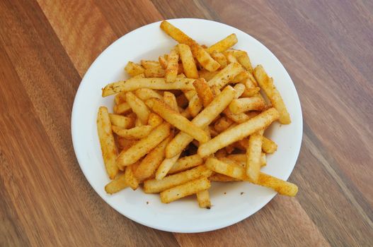 Spice golden french fries on a plate