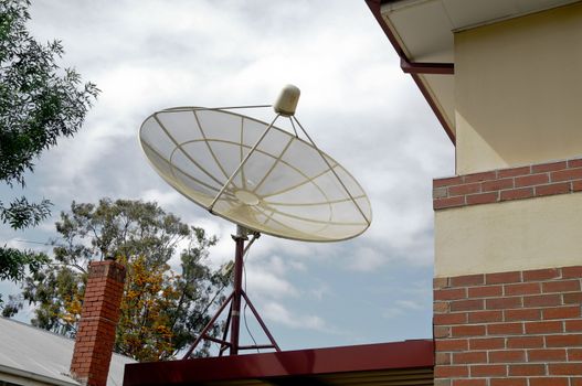 Satellite installed on a house in cloudy day