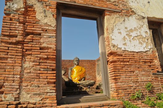 Window view to Ayudhaya old Buddha statue Thailand