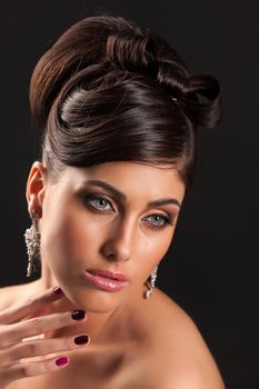 Young beautiful woman in a wedding dress on a studio background