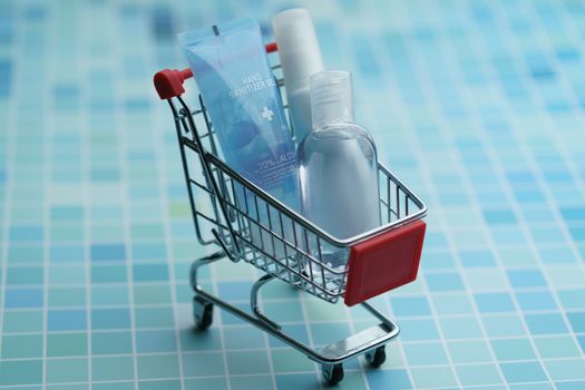 Shopping cart with must have items hand sanitizer, corona virus or Covid-19 protection.