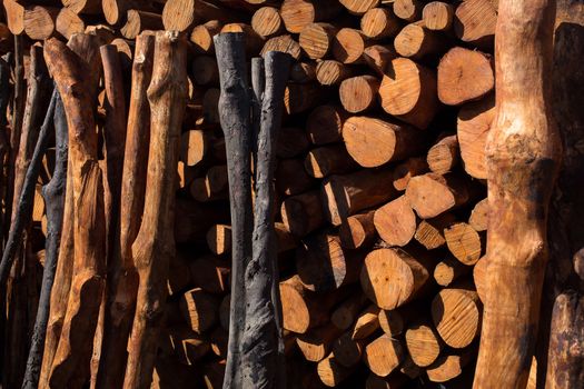 Firewood stacked and prepared for winter Pile of wood logs.