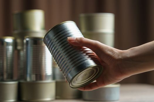 Woman hand with group of Aluminium canned food.