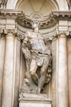 Marble statue of Saint Mark complete with his attribute, the lion. Facade of the Scalzi church in Cannaregio, Venice, Italy.