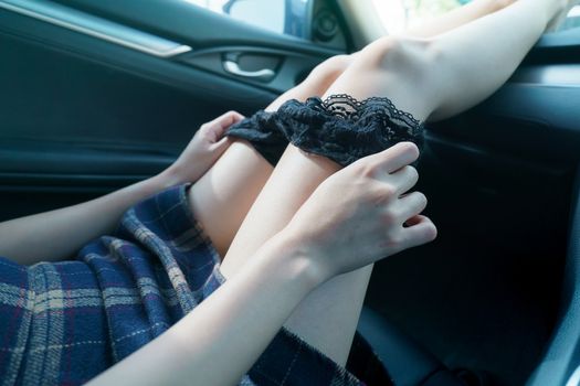 sex in car concept : woman take off her panty in a car.