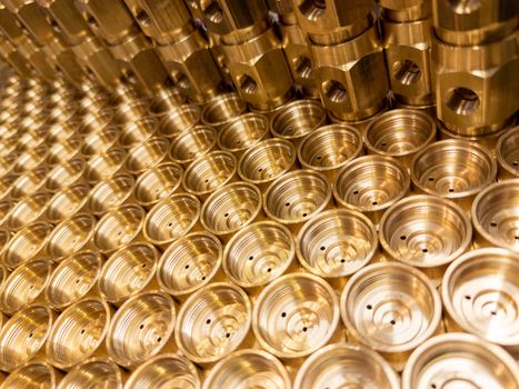 shiny brass metal threaded hexagonal fitting parts, abstract perspective industrial close-up background.