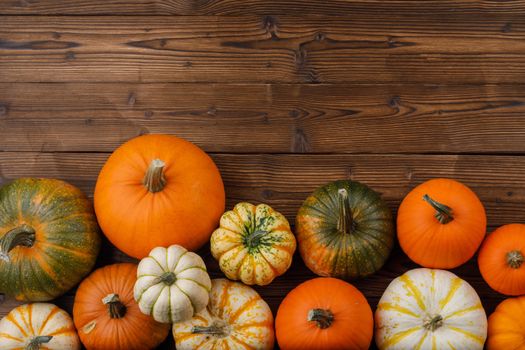 Many orange pumpkins on wooden background , Halloween concept , top view with copy space