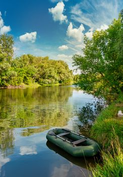 Inflatable boat on river at the sunrise