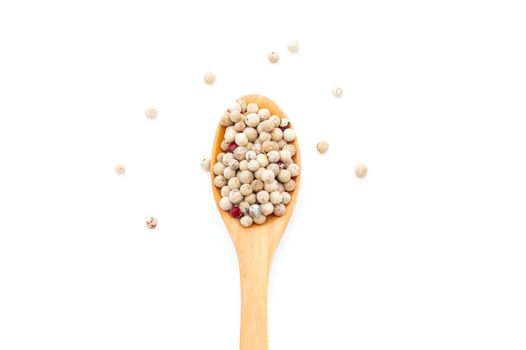 Pepper spices in a wooden spoon on a white background  