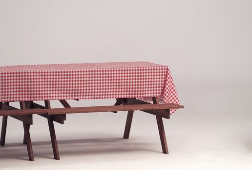 Wood table and red napkin for outdoor party and white background.