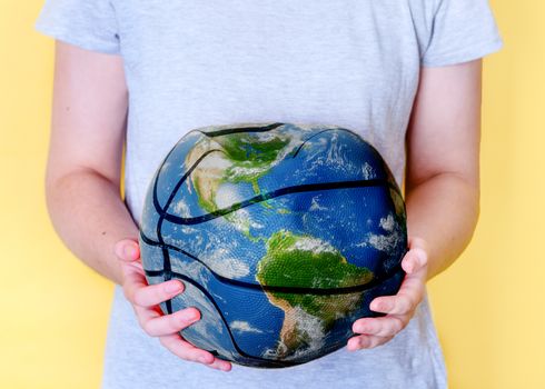 Girl holding crushed globe, save the planet