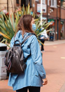 Asian woman wearing a face mask walking around city and shopping