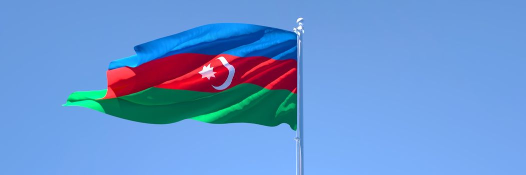 3D rendering of the national flag of Azerbaijan waving in the wind against a blue sky