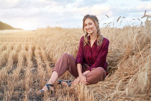 Woman farmer sitting farmland smiling Female agronomist specialist farming agribusiness Happy positive caucasian worker agricultural field dressed red checkered shirt and bandana Red plaid shirt.