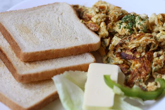Breakfast with toast butter and scrambled eggs