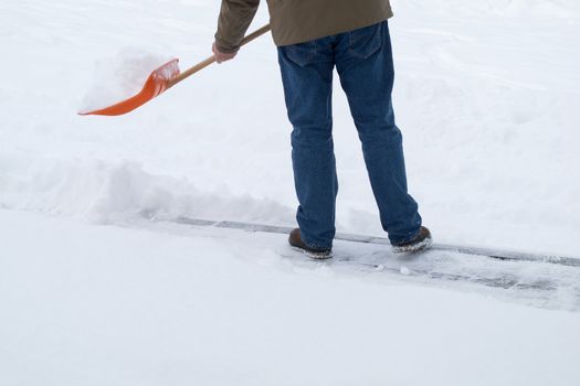 Man shoveling snow at wintertime