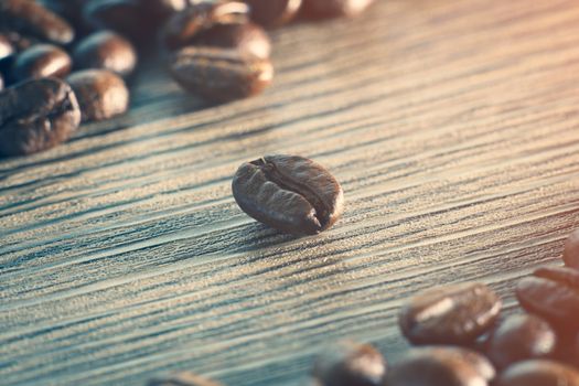 Coffee beans. On a wooden background.