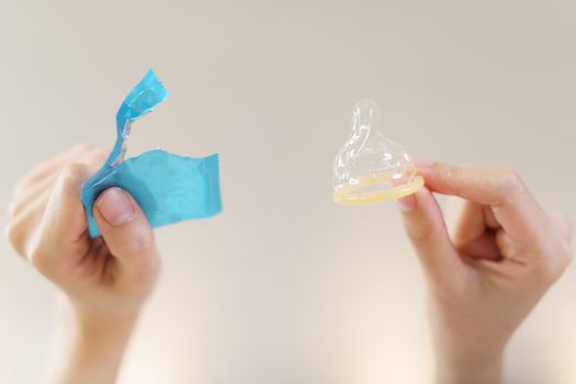 Condom ready to use in female hand safe sex concept.