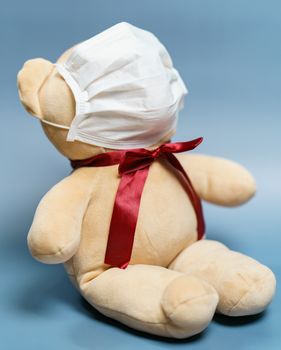 Teddy bear wearing face mask. Protection epidemic Coronavirus, Covid-19.