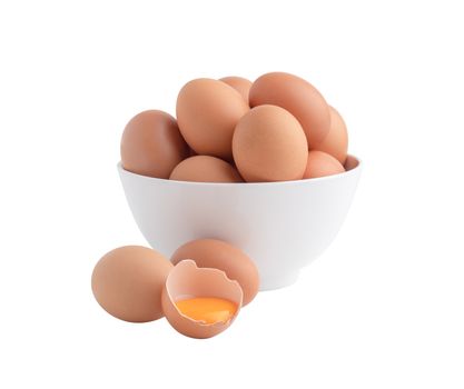 Chicken eggs in the white bowl and one egg is broken with the yolk on the floor.. Raw food isolated on the white background with clipping paths