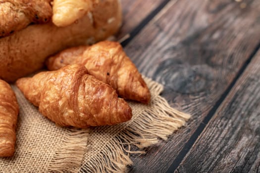 Croissants on the sack and wooden table
