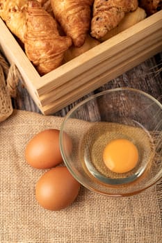 Eggs for make bakery on the sack with breads on the table