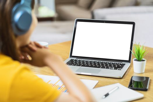 Back side of Asian business woman using laptop with white screen for creative and design in modern of house, working from home and stay at home when covid-19 outbreak,blank screen mockup copy space