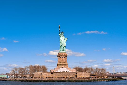The Statue of Liberty under the blue sky background, Lower Manhattan, New York City, United state of America, Architecture and building with tourist concept