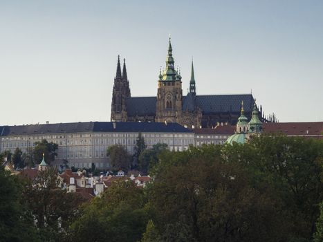 St. Vitus Cathedral gothic churche and Prague Castle panorama with hradcany and green trees on a late Summer afternoon.