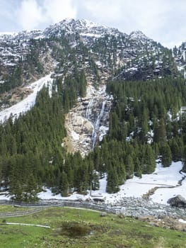 GRAWA Wasserfall Glacier Waterfall situated in Stubai Valley, Tyrol, Austria. Spring mountain river and trees landscape natural environment. Hiking in the alps