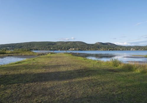 Vew on Sjalevadsfjarden lake in ornskoldsvik city in Vasternorrland region of Sweden. Summer sunny day, blue sky background.