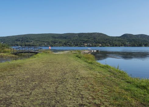 Vew on Sjalevadsfjarden lake in ornskoldsvik city in Vasternorrland region of Sweden. Summer sunny day, blue sky background.