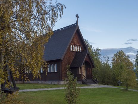 Traditional wooden Church in Kvikkjokk built in 1906, located in northern Sweden Lapland. End of gamous Kungsleden trail passes over the village. Early autumn, golden hour