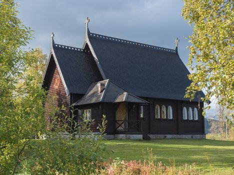 Traditional wooden Church in Kvikkjokk built in 1906, located in northern Sweden Lapland. End of gamous Kungsleden trail passes over the village. Early autumn, golden hour