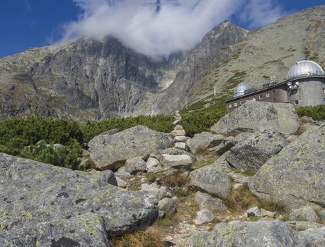 View on mountain Peak Lomnicky stit 2 634 m covered in clouds at Summer with Skalnate pleso Observatory, second highest mountain peak in the High Tatras mountains of Slovakia, Vysoke Tatry.