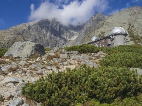 View on mountain Peak Lomnicky stit 2 634 m covered in clouds at Summer with Skalnate pleso Observatory, second highest mountain peak in the High Tatras mountains of Slovakia, Vysoke Tatry.