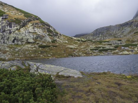 Pleso nad Skokom, beautiful mountain lake in Mlynicka Dolina Valley with hiking peoples on footpath High Tatras mountain, Vysoke Tatry , Slovakia.