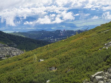 Valley Mlynska Dolina in slovakia mountains with Panoramic view on Strbske pleso village and green slope, High Tatra Mountains, Slovakia, summer.
