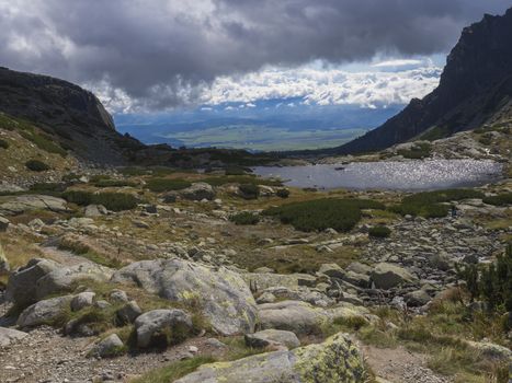 Valley Mlynska Dolina in slovakia mountains with view on Strbske pleso village and mountain lake Pleso Nad Skokom, High Tatra Mountains, Slovakia, summer day