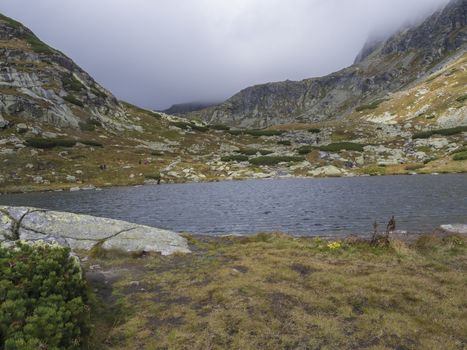 Pleso nad Skokom, beautiful mountain lake in Mlynicka Dolina Valley with hiking peoples on footpath High Tatras mountain, Vysoke Tatry , Slovakia.