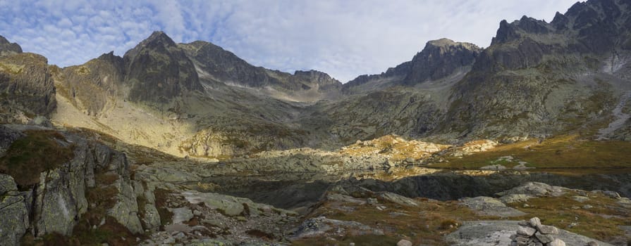 Panoramic view on mountain lake Prostredne Spisske pleso at the end of the hiking route to the Teryho Chata mountain shelter in the High Tatras in Slovakia.