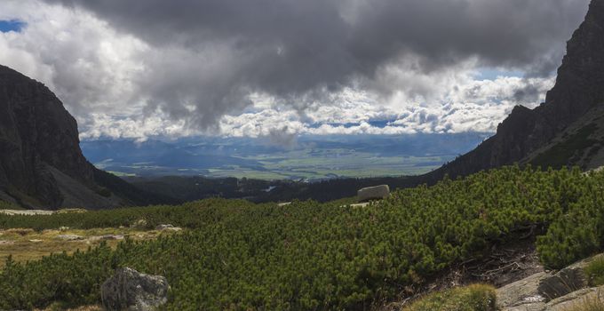 Valley Mlynska Dolina in slovakia mountains with Panoramic view on Strbske pleso village and mountain lake, High Tatra Mountains, Slovakia, summer day