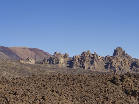 view on famous rock formation  Roques de Garcia and colorful volcanic mountain and lava desert on tenerife canary island unesco protected landscape el teide national park