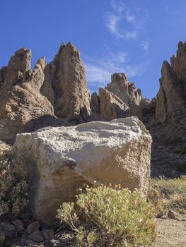 big white square stone with view on famous rock formation Roques de Garcia on tenerife canary island unesco protected landscape, blue sky background